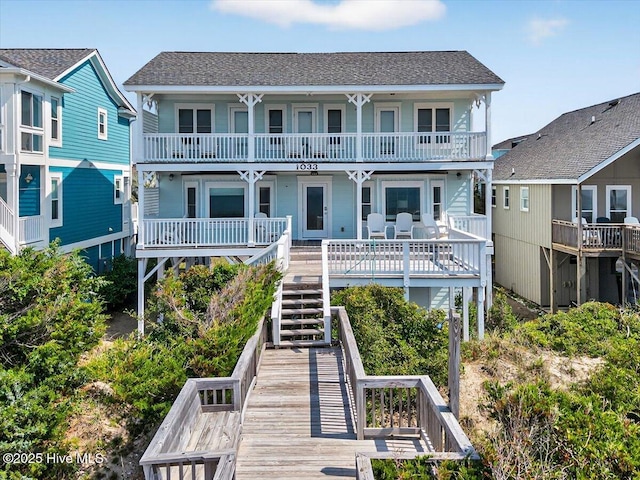 1033 Ocean Blvd W, Holden Beach, NC 28462 - back of house featuring a shingled roof and stairway