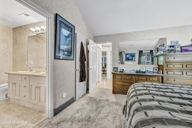 208 Bloomington Ln, Wilmington, NC 28411 - bedroom featuring a sink, a textured ceiling, ensuite bath, and lofted ceiling
