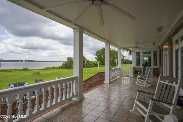 4 Hunter Heath Dr, North Topsail Beach, NC 28460 - porch featuring a water view, a ceiling fan, and a lawn