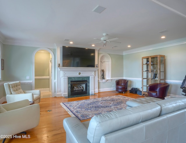 4 Hunter Heath Dr, North Topsail Beach, NC 28460 - living room with a ceiling fan, ornamental molding, arched walkways, light wood finished floors, and recessed lighting