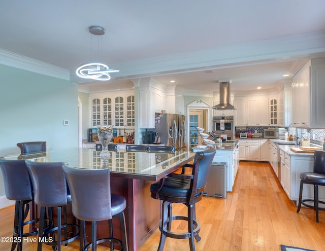4 Hunter Heath Dr, North Topsail Beach, NC 28460 - kitchen featuring island exhaust hood, a kitchen island, white cabinets, ornamental molding, and recessed lighting