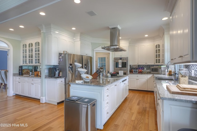 4 Hunter Heath Dr, North Topsail Beach, NC 28460 - kitchen featuring island exhaust hood, light wood-style floors, stainless steel appliances, white cabinetry, and recessed lighting