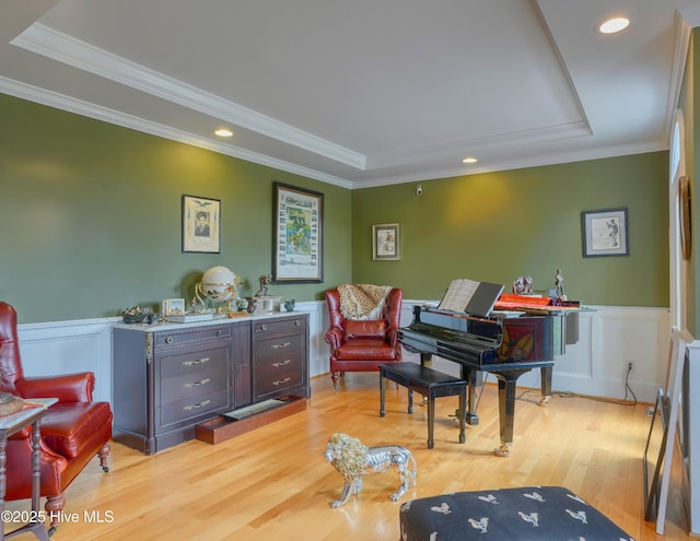 4 Hunter Heath Dr, North Topsail Beach, NC 28460 - sitting room with a raised ceiling, light wood-style flooring, a wainscoted wall, crown molding, and recessed lighting