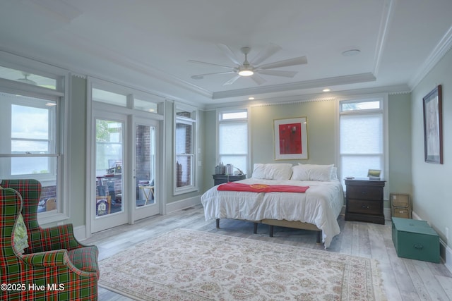 4 Hunter Heath Dr, North Topsail Beach, NC 28460 - bedroom featuring crown molding, a tray ceiling, wood finished floors, access to exterior, and ceiling fan