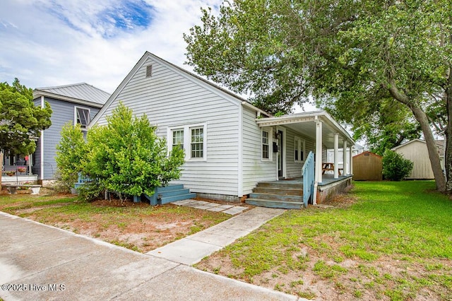 1407 Arendell St, Morehead City, NC 28557 - view of front facade featuring a front yard and covered porch