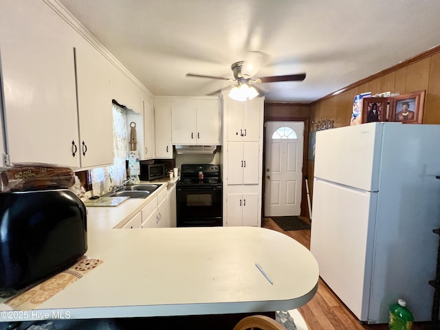 1144 Nashville Rd, Rocky Mount, NC 27803 - kitchen with black range with electric cooktop, freestanding refrigerator, a sink, wood finished floors, and light countertops