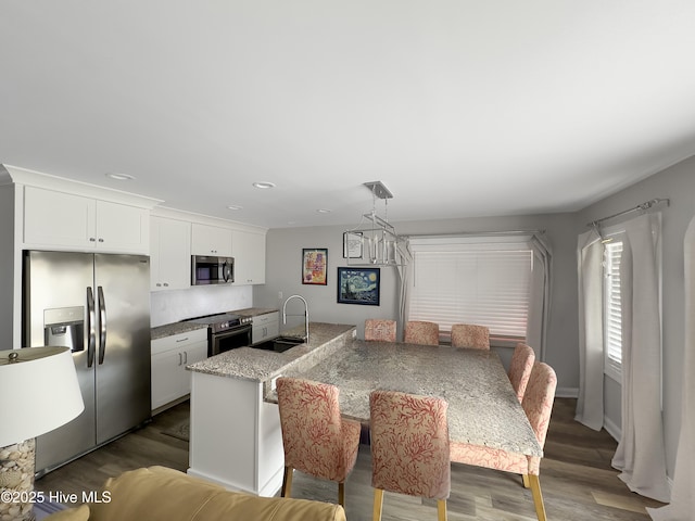 7411 Ocean Dr Unit E & W, Emerald Isle, NC 28594 - kitchen with stainless steel appliances, a sink, white cabinets, dark wood-type flooring, and recessed lighting