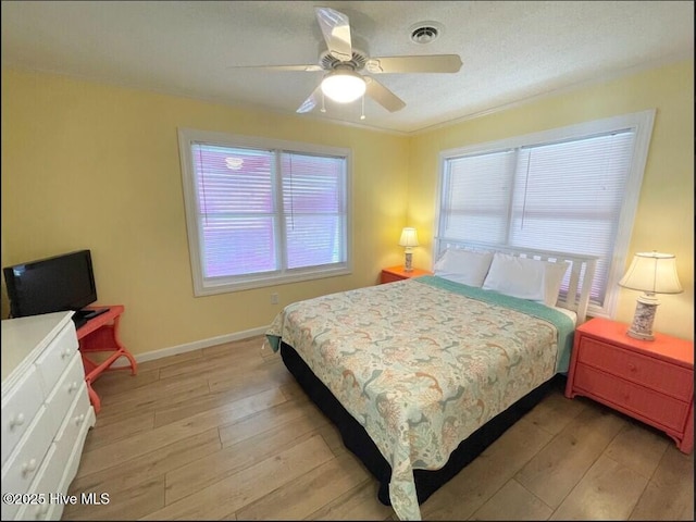7411 Ocean Dr Unit E & W, Emerald Isle, NC 28594 - bedroom with light wood-style floors, baseboards, a ceiling fan, and crown molding