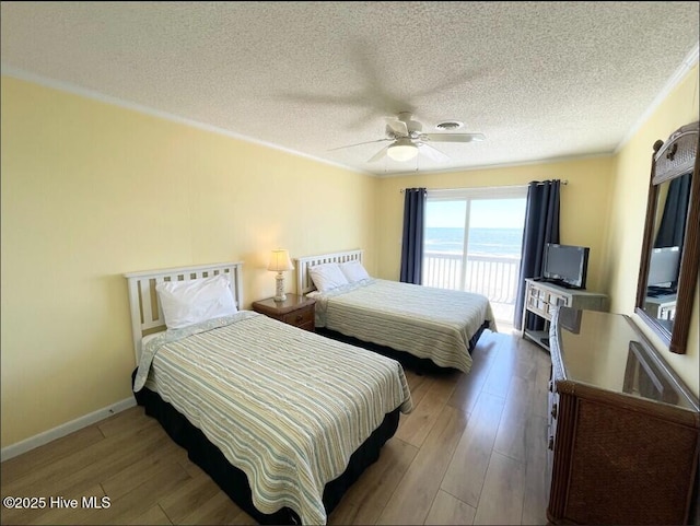 7411 Ocean Dr Unit E & W, Emerald Isle, NC 28594 - bedroom featuring wood finished floors, access to exterior, a textured ceiling, ceiling fan, and baseboards