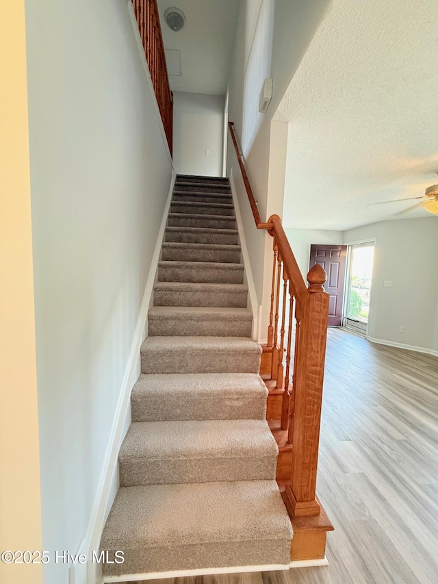 2104 Flagstone Ct Unit A-4, Greenville, NC 27834 - stairway featuring wood finished floors, a ceiling fan, and baseboards