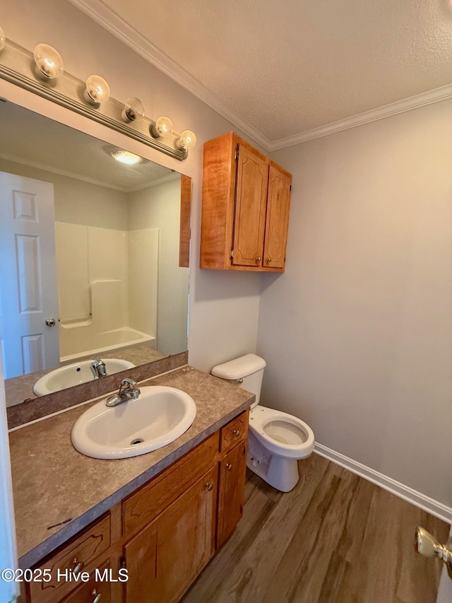 2104 Flagstone Ct Unit A-4, Greenville, NC 27834 - bathroom featuring wood finished floors, vanity, toilet, ornamental molding, and a textured ceiling