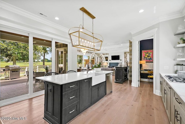 1830 Senova Trce, Wilmington, NC 28405 - kitchen featuring dark cabinetry, light countertops, ornamental molding, open floor plan, and recessed lighting
