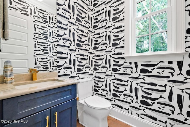 1830 Senova Trce, Wilmington, NC 28405 - half bathroom featuring vanity, wallpapered walls, healthy amount of natural light, and wood finished floors
