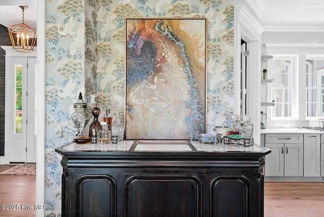 1830 Senova Trce, Wilmington, NC 28405 - bar with wallpapered walls, wood finished floors, ornamental molding, and a chandelier