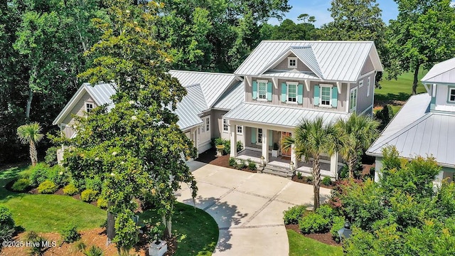 1830 Senova Trce, Wilmington, NC 28405 - view of front of property featuring a standing seam roof, a porch, a metal roof, driveway, and a garage