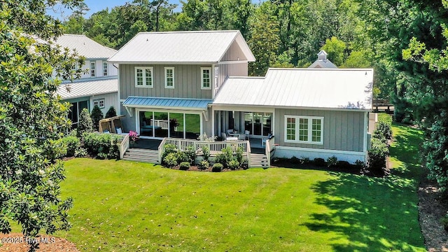 1830 Senova Trce, Wilmington, NC 28405 - back of house featuring a lawn, a metal roof, board and batten siding, and a standing seam roof