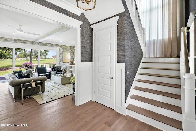 1830 Senova Trce, Wilmington, NC 28405 - stairway featuring wallpapered walls, wood finished floors, ceiling fan, and beam ceiling