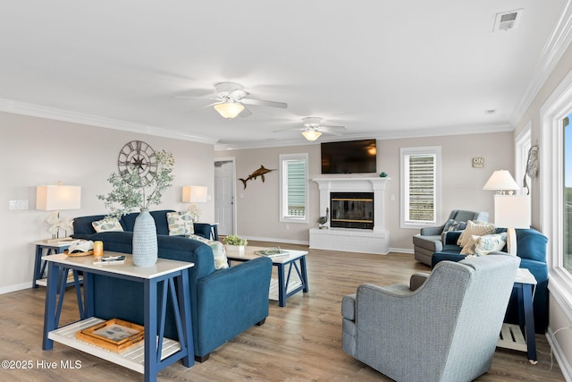 1239 Ocean Blvd W, Holden Beach, NC 28462 - living room featuring healthy amount of natural light, a ceiling fan, light wood-style flooring, crown molding, and a fireplace