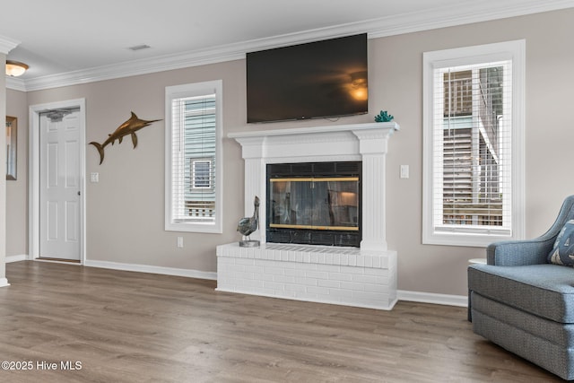 1239 Ocean Blvd W, Holden Beach, NC 28462 - living room featuring ornamental molding, wood finished floors, and a glass covered fireplace
