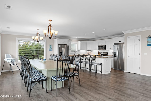 1239 Ocean Blvd W, Holden Beach, NC 28462 - dining space with a chandelier, ornamental molding, dark wood-style floors, and recessed lighting