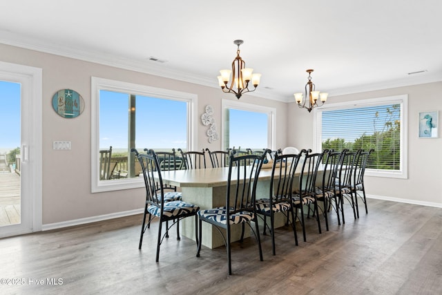 1239 Ocean Blvd W, Holden Beach, NC 28462 - dining area with a chandelier, healthy amount of natural light, wood finished floors, and crown molding