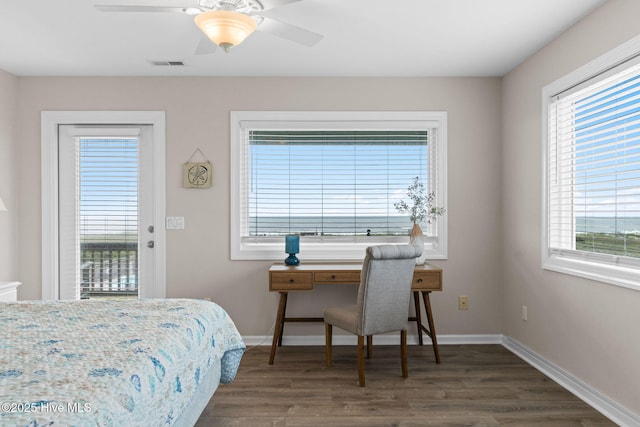1239 Ocean Blvd W, Holden Beach, NC 28462 - bedroom featuring multiple windows, wood finished floors, and access to outside