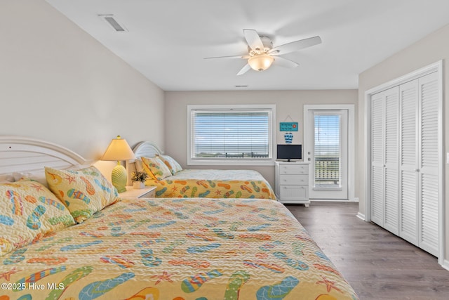 1239 Ocean Blvd W, Holden Beach, NC 28462 - bedroom with multiple windows, wood finished floors, a ceiling fan, and a closet