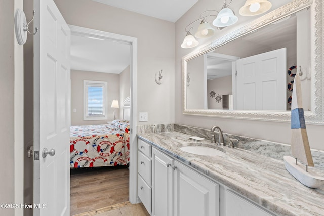 1239 Ocean Blvd W, Holden Beach, NC 28462 - bathroom with vanity, connected bathroom, and wood finished floors