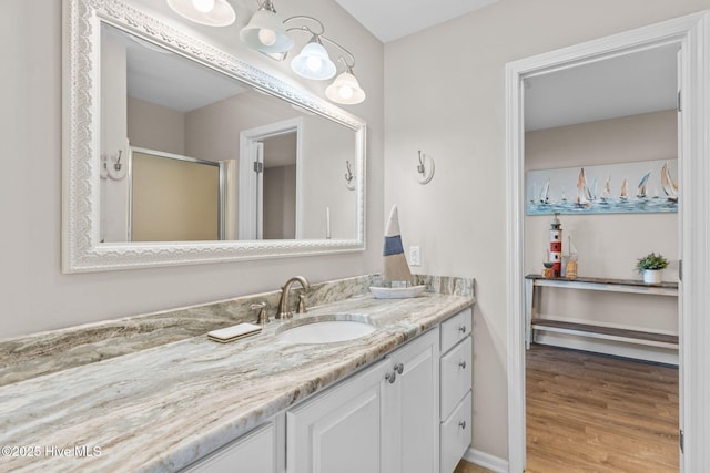 1239 Ocean Blvd W, Holden Beach, NC 28462 - full bathroom featuring vanity, a stall shower, and wood finished floors