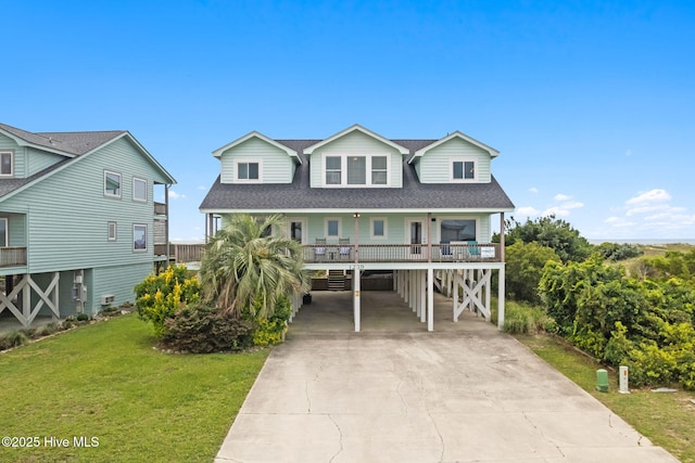 1239 Ocean Blvd W, Holden Beach, NC 28462 - beach home featuring a carport, concrete driveway, a porch, a front lawn, and a shingled roof
