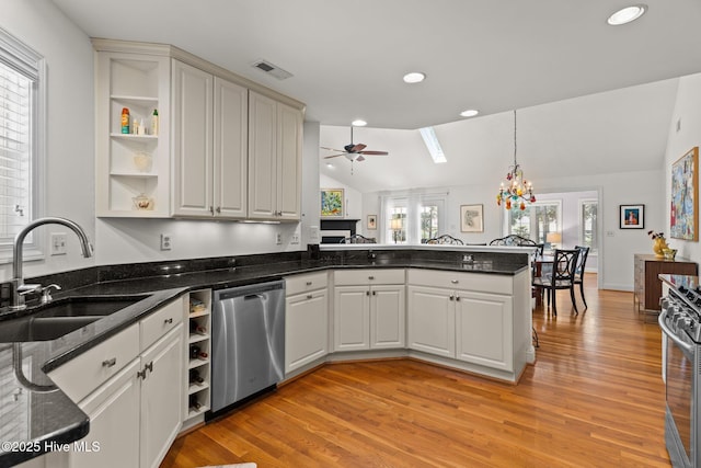 5752 Gardenia Ln, Wilmington, NC 28409 - kitchen with stainless steel appliances, open shelves, a sink, a peninsula, and vaulted ceiling
