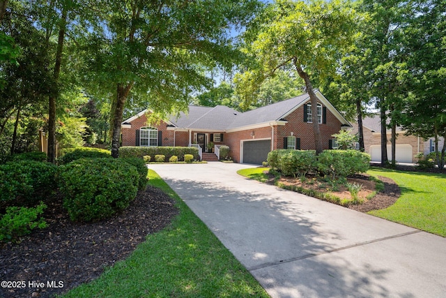 5752 Gardenia Ln, Wilmington, NC 28409 - view of front of house featuring concrete driveway, a garage, brick siding, and a front lawn