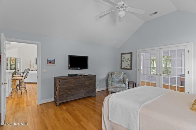 5752 Gardenia Ln, Wilmington, NC 28409 - bedroom featuring lofted ceiling, french doors, light wood-style flooring, and baseboards