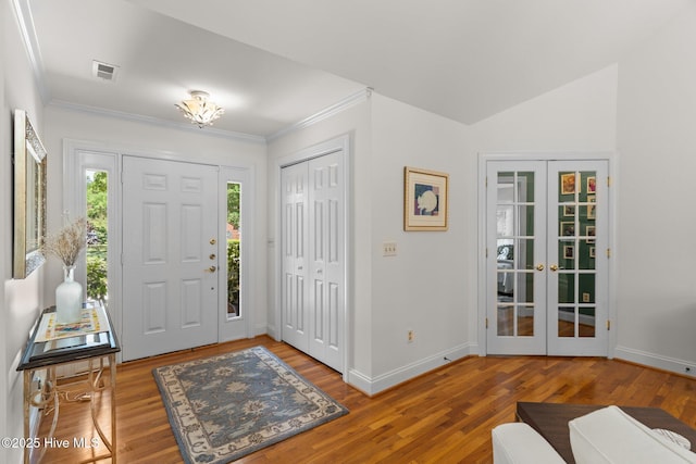 5752 Gardenia Ln, Wilmington, NC 28409 - foyer featuring french doors, wood finished floors, baseboards, and crown molding