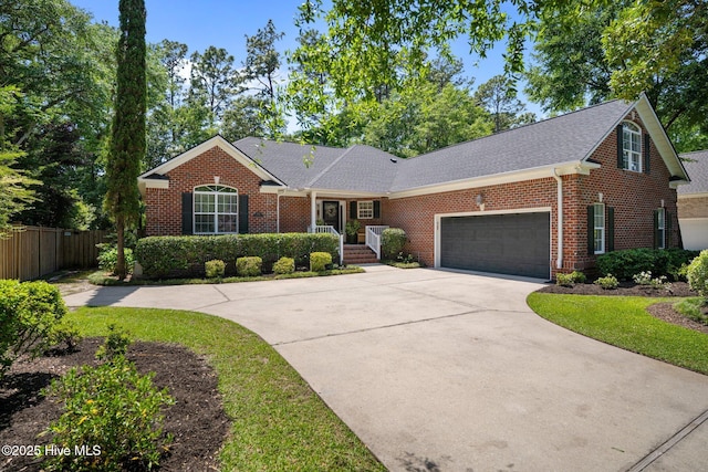 5752 Gardenia Ln, Wilmington, NC 28409 - view of front of house featuring brick siding, concrete driveway, an attached garage, and roof with shingles