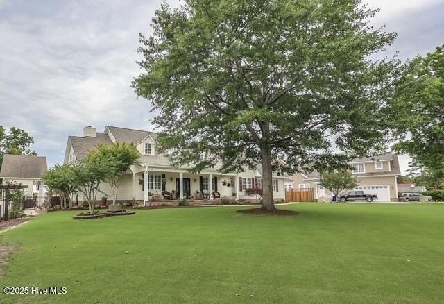 1 Burton Pl, Jacksonville, NC 28540 - view of front of home featuring a front yard, a chimney, and covered porch