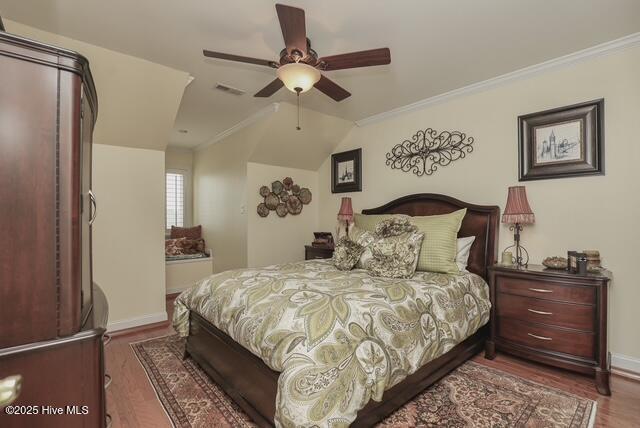 1 Burton Pl, Jacksonville, NC 28540 - bedroom featuring wood finished floors, vaulted ceiling, crown molding, and ceiling fan