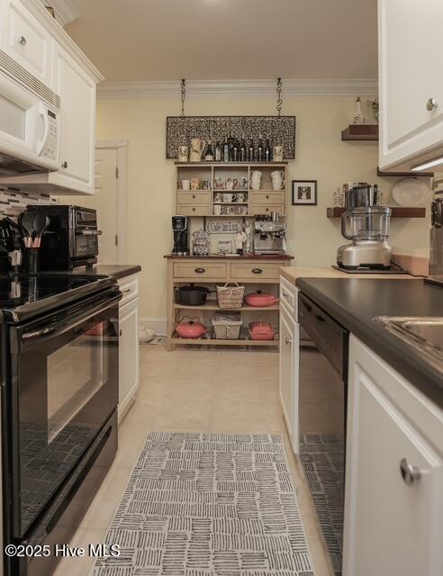 1 Burton Pl, Jacksonville, NC 28540 - kitchen featuring black appliances, crown molding, white cabinets, dark countertops, and light tile patterned floors