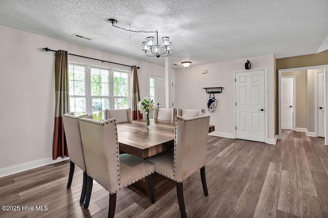 648 Pine Branches Cir SE, Leland, NC 28451 - dining space featuring a chandelier, wood finished floors, and a textured ceiling