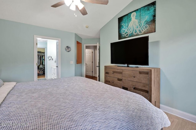 648 Pine Branches Cir SE, Leland, NC 28451 - bedroom with wood finished floors, vaulted ceiling, ceiling fan, a walk in closet, and a closet