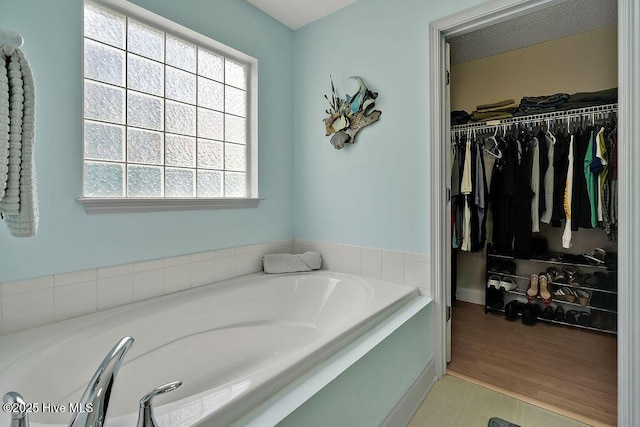 648 Pine Branches Cir SE, Leland, NC 28451 - bathroom featuring a bath and a spacious closet