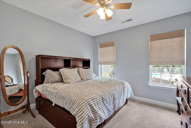 648 Pine Branches Cir SE, Leland, NC 28451 - bedroom with light colored carpet, ceiling fan, and a textured ceiling