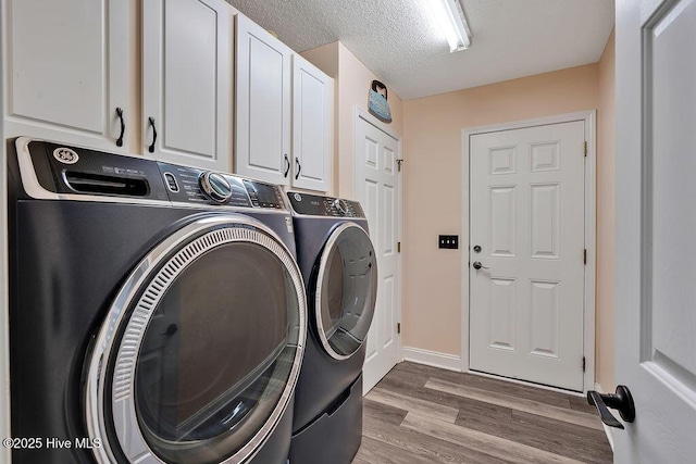 648 Pine Branches Cir SE, Leland, NC 28451 - laundry room featuring washer and dryer, cabinet space, wood finished floors, and a textured ceiling