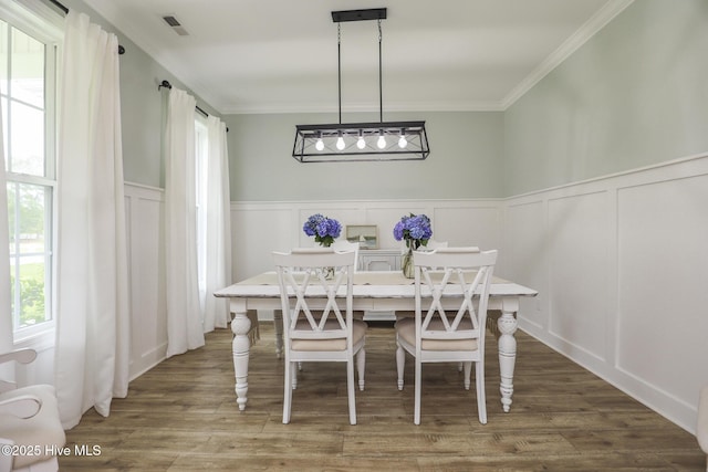 637 White Oak Xing, Swansboro, NC 28584 - dining room with a decorative wall, ornamental molding, wood finished floors, and a wainscoted wall