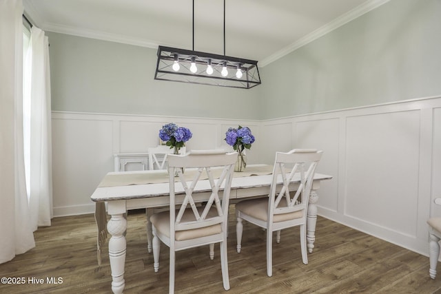 637 White Oak Xing, Swansboro, NC 28584 - dining area with ornamental molding, a decorative wall, wood finished floors, and wainscoting