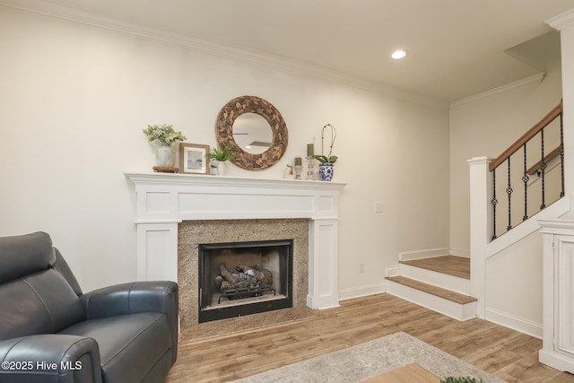 637 White Oak Xing, Swansboro, NC 28584 - living room featuring stairway, light wood finished floors, recessed lighting, ornamental molding, and a fireplace
