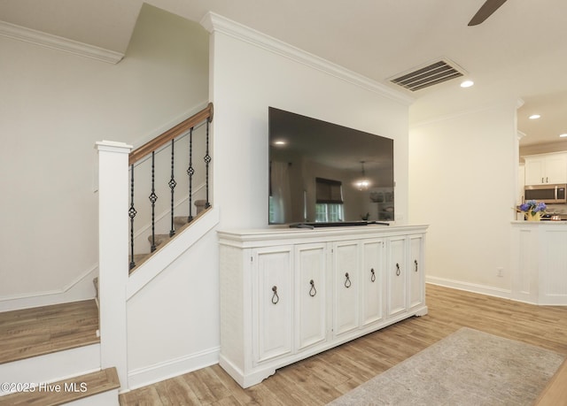637 White Oak Xing, Swansboro, NC 28584 - interior space featuring crown molding, stainless steel microwave, wood finished floors, a ceiling fan, and recessed lighting