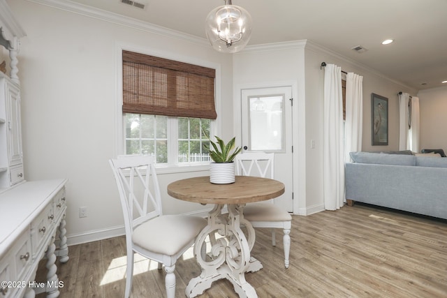 637 White Oak Xing, Swansboro, NC 28584 - dining space featuring light wood finished floors, crown molding, recessed lighting, and a chandelier