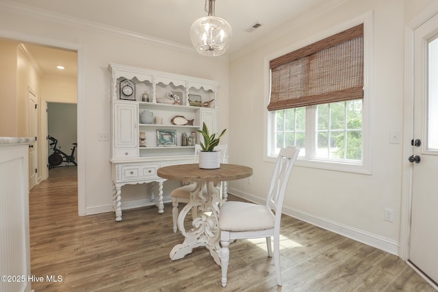 637 White Oak Xing, Swansboro, NC 28584 - dining room with crown molding, light wood finished floors, and a chandelier