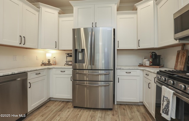 637 White Oak Xing, Swansboro, NC 28584 - kitchen with stainless steel appliances, white cabinets, and light wood finished floors
